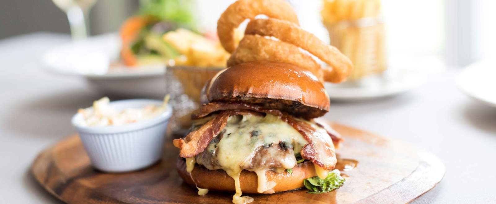 Devon Hotel Restaurant Dining Bacon and Cheese Burger with Onion Rings and Chips