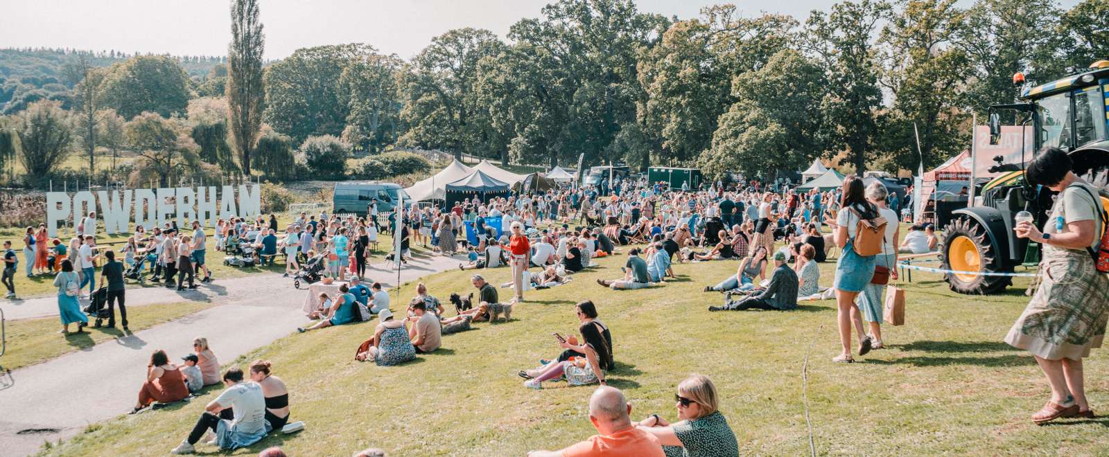 People at an event at Powderham Castle on a sunny day