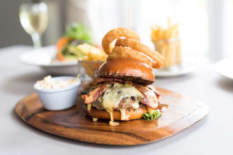 Devon Hotel Restaurant Dining Bacon and Cheese Burger with Onion Rings and Chips