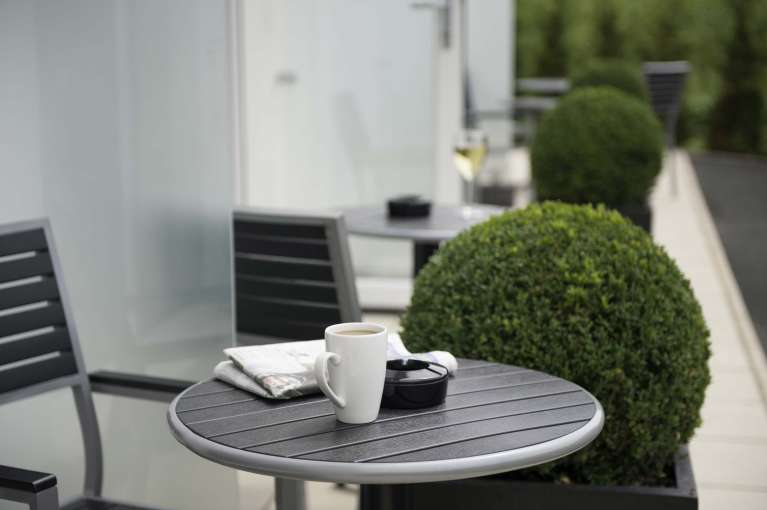 Devon Hotel Accommodation Outdoor Patio Area Table with Coffee and Newspaper