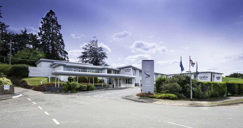 Devon Hotel Exterior with Sign and Flags