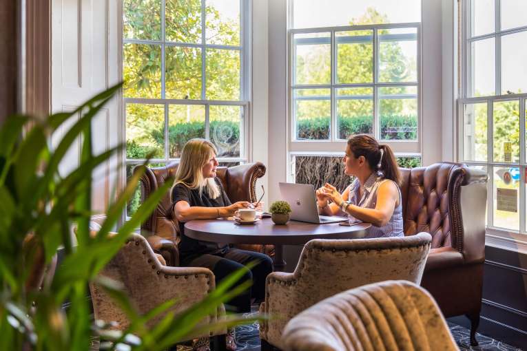 Devon Hotel Carriages Restaurant Two Guests Having a Meeting over Coffees