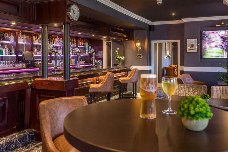 Devon Hotel Carriages Restaurant Bar Seating Area with Television