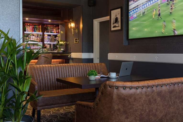 Devon Hotel Carriages Restaurant Bar Seating Area with Television