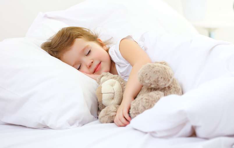 child asleep in bed