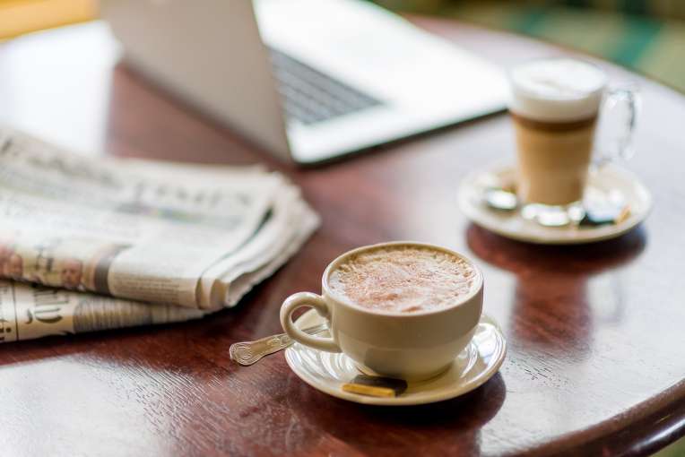 coffees with laptop and newspaper