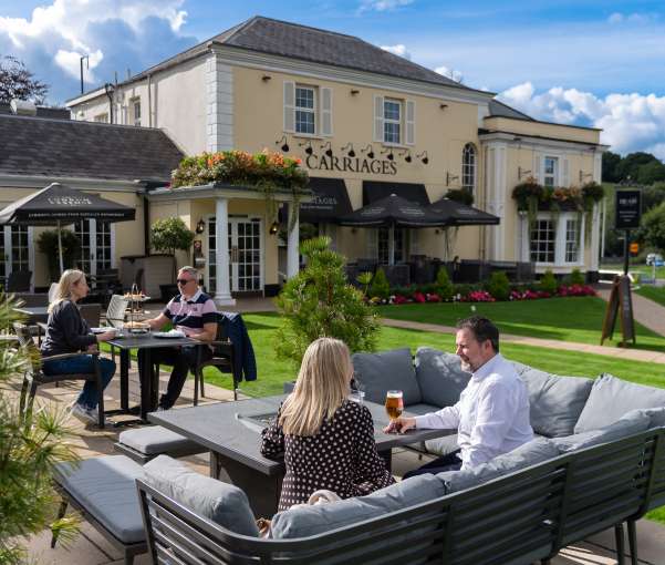 People sitting outside and having a drink at The Devon Hotel 