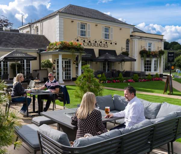 People sitting outside and having a drink at The Devon Hotel 