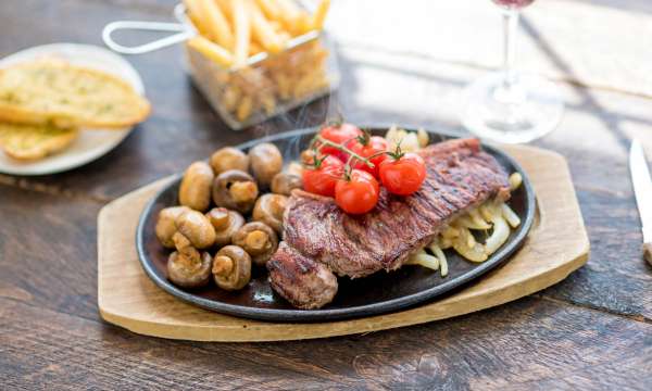 Devon Hotel Restaurant Dining Steak with Onion Vine Tomatoes Mushrooms and Chips