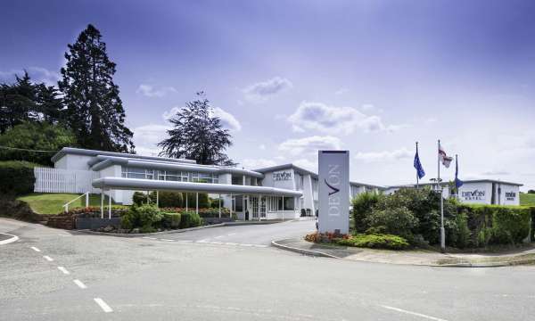 Devon Hotel Exterior with Sign and Flags