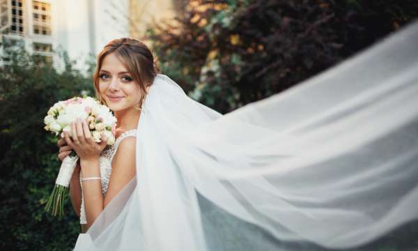 Bride smiling with her bouquet