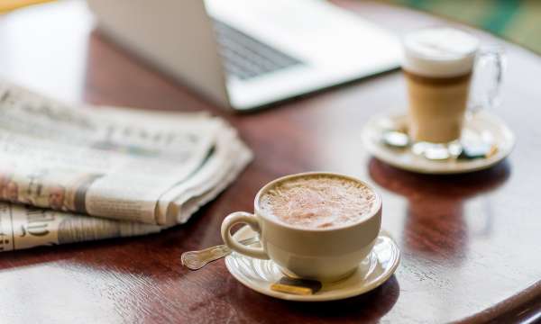 coffees with laptop and newspaper