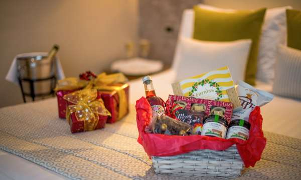 festive hamper and champagne in bedroom