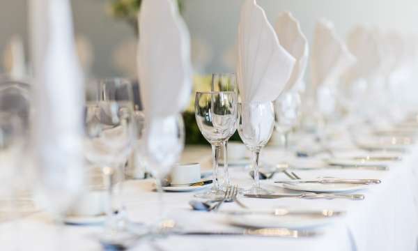 white napkins in glasses on table