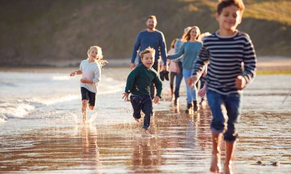 family running on beach