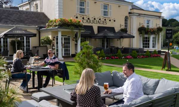 People sitting outside and having a drink at The Devon Hotel 