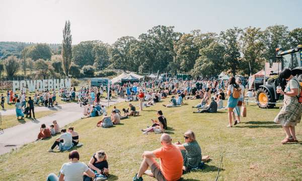 People at an event at Powderham Castle on a sunny day