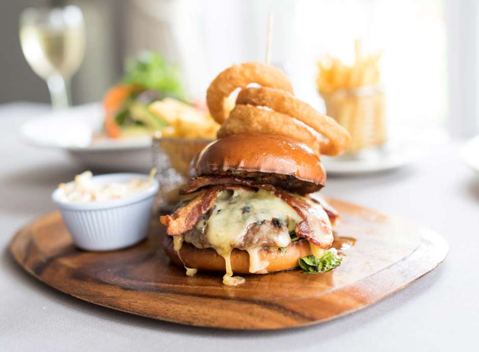 Devon Hotel Restaurant Dining Bacon and Cheese Burger with Onion Rings and Chips