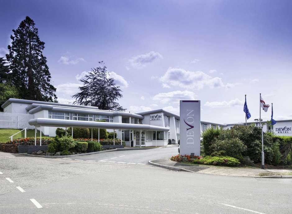 Devon Hotel Exterior with Sign and Flags