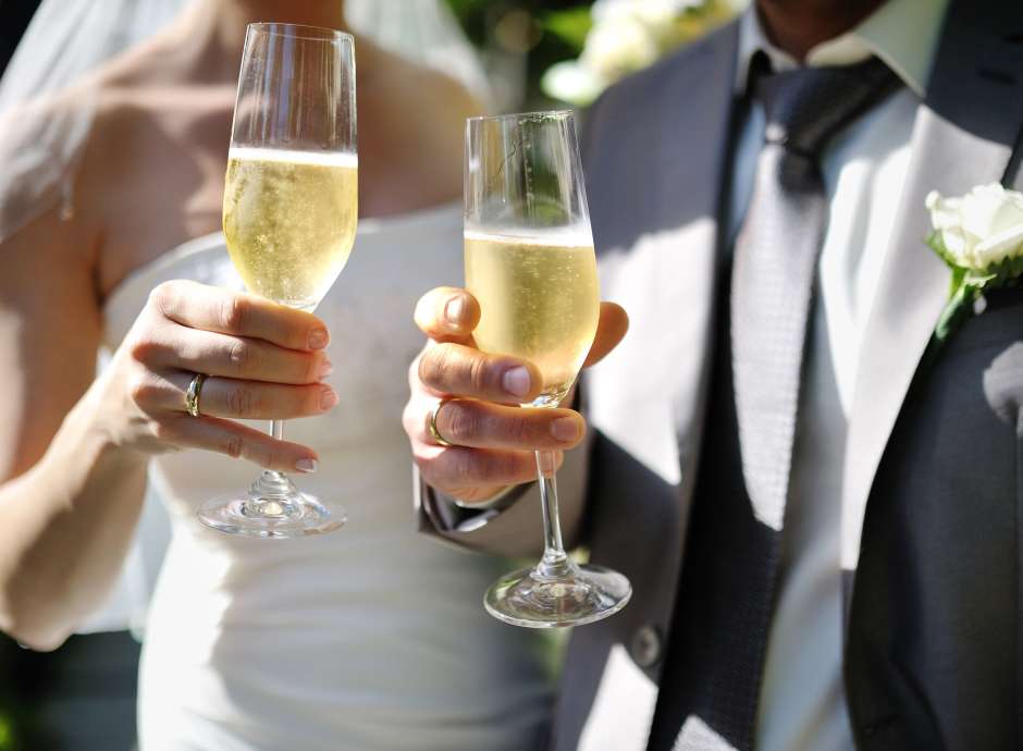 Bride and Groom toasting with champagne at their wedding