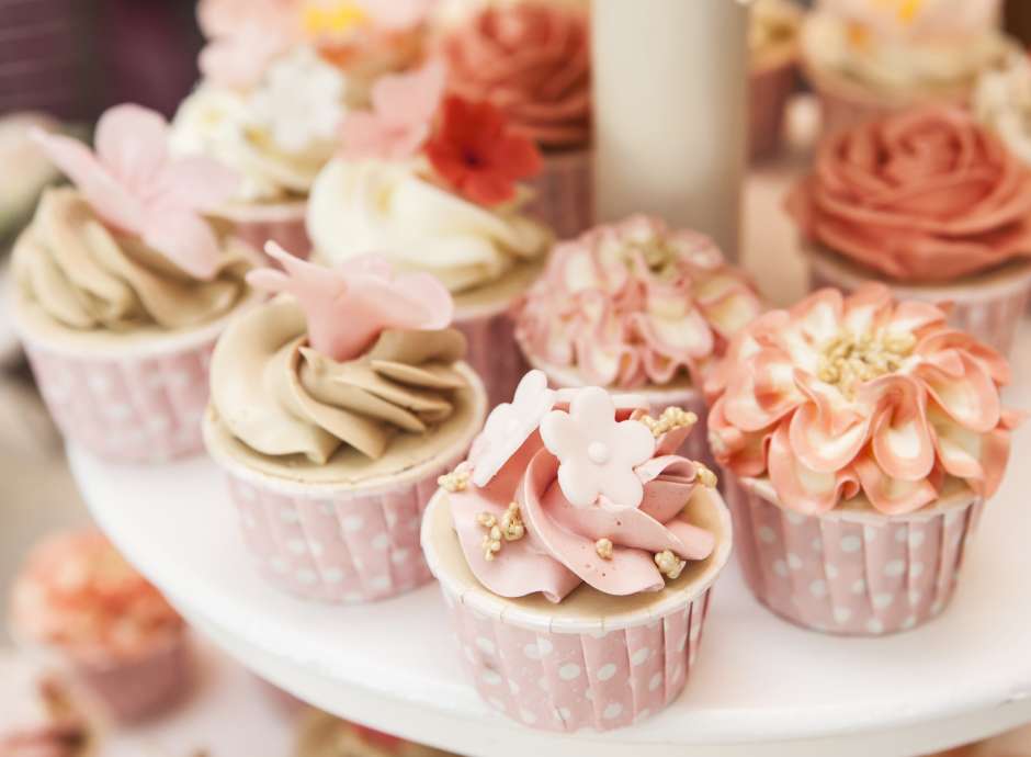 Floral cupcakes on cake stand at a wedding