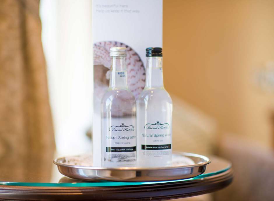 Bottled Water set on a bedroom table on Arrival