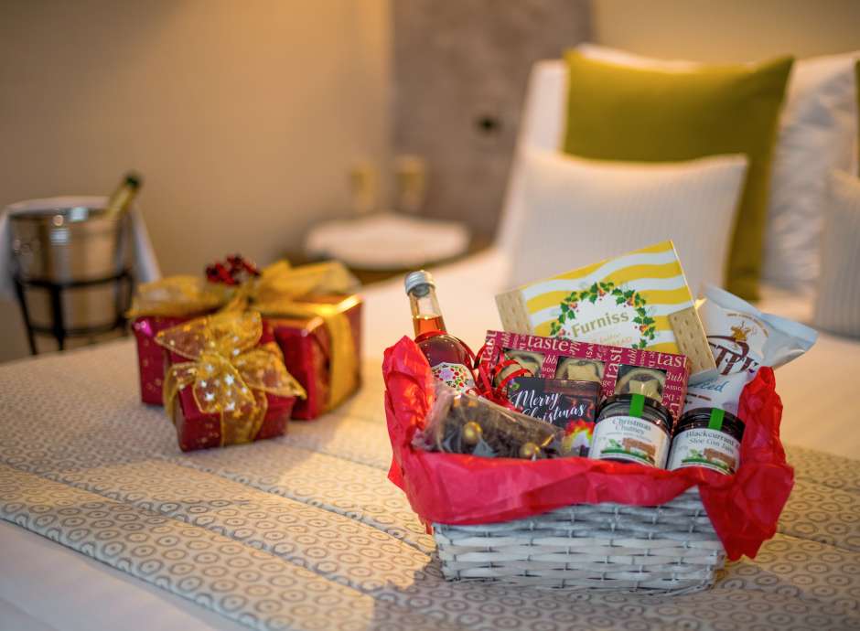 festive hamper and champagne in bedroom