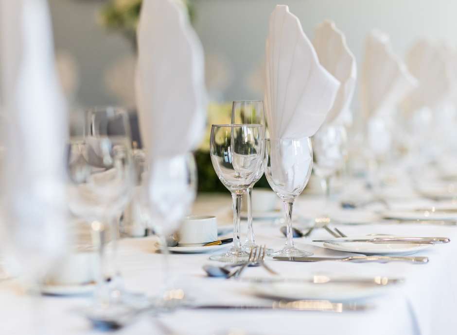 white napkins in glasses on table
