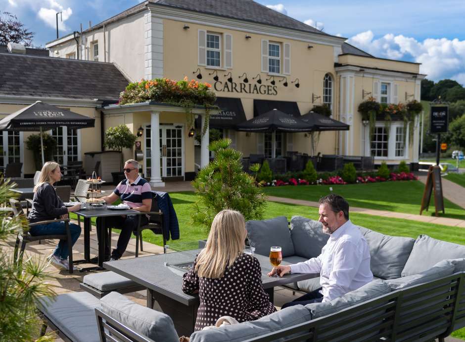 People sitting outside and having a drink at The Devon Hotel